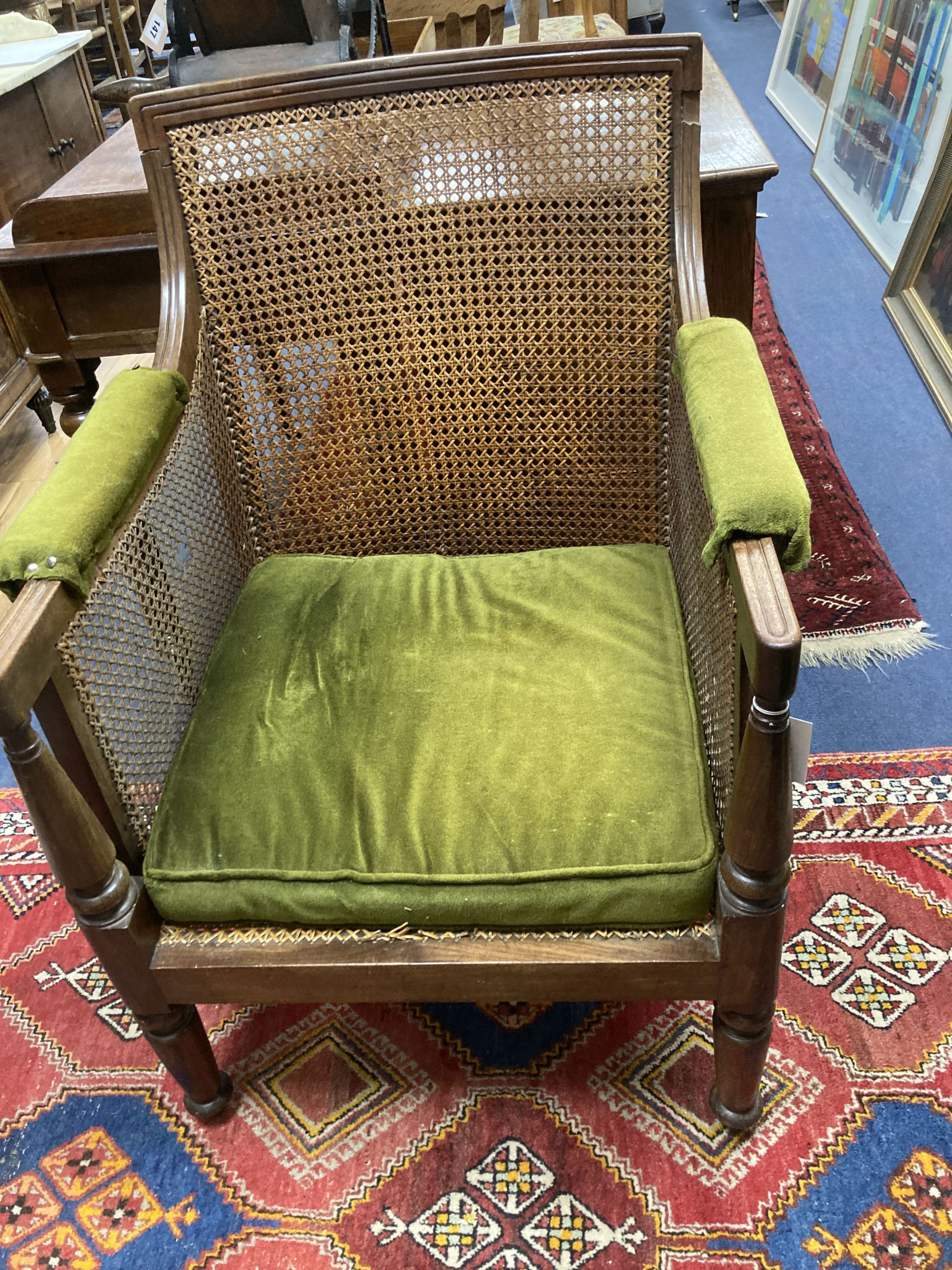 A Regency mahogany bergere armchair, width 67cm, depth 64cm, height 92cm